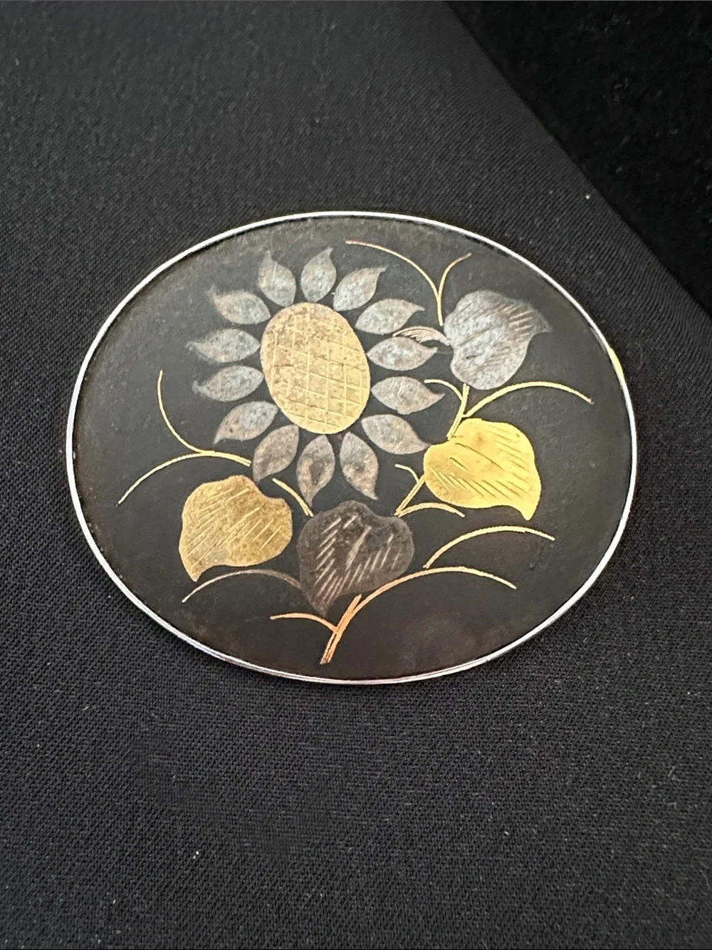 Vintage damascene GUC oval brooch. Sunflower theme in gold & silver on black
